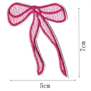 Pink bow embroidered patch detail shot, ribbon applique for clothing, hair accessories.