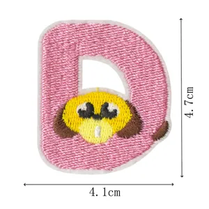 Detailed view of pink letter D embroidered patch with cute yellow puppy design, close-up.