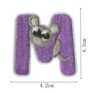 Close-up detail of a cute purple letter M embroidered patch with a playful grey mouse.