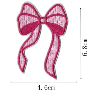 Detailed view of pink embroidered bow patch showing precise dimensions for DIY sewing and crafts.