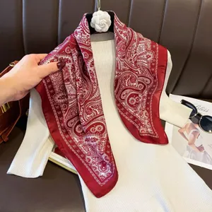 Detailed view of the red and white paisley print square satin scarf, elegant silk shawl.