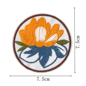 Round floral embroidered patch with detailed orange and blue flower design, 7.5cm size.