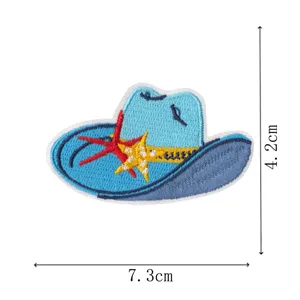Close up of blue cowboy hat embroidery patch with starfish design, detailed stitching craft.