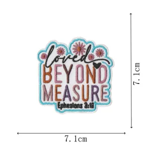 Detailed shot of the embroidered patch featuring floral designs and encouraging scripture text.