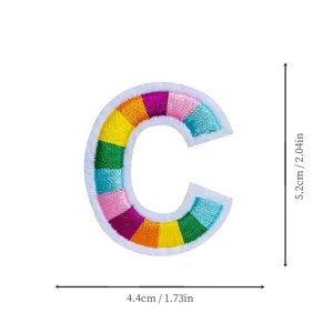 Colorful embroidered letter C patch detail view, rainbow fabric applique for DIY clothing repair