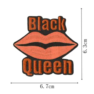 Close-up view of custom embroidery patch showing detailed black and orange lip design.