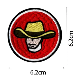 Detailed shot of a round embroidered cowboy patch with red background, high quality craft.