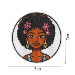 Round embroidered patch featuring a cute afro girl design with floral details, 7cm size.