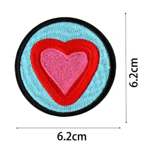 Round embroidered patch featuring layered pink and red hearts with blue background, 6.2cm size.