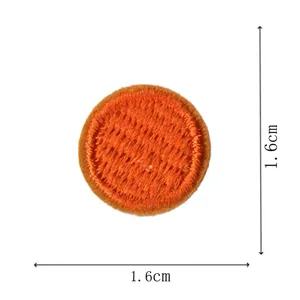 Orange round embroidered patch detail shot, 1.6cm mini cloth badge sticker for clothing.