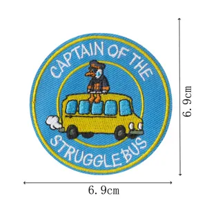 Detailed view of a cute cartoon duck captain embroidered patch for jacket and bag decoration.
