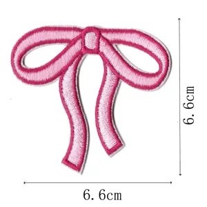 Close-up detail of the pink embroidered bow patch showing fine stitching and clear dimensions.