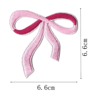 Pink ribbon bow embroidered patch detail shot, showing precise craftsmanship and size measurements.