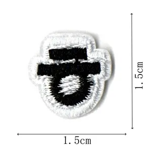 Close-up detail of small black and white embroidered patch, size 1.5x1.5cm, ideal for apparel decor.