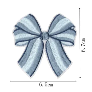 Close-up detail of the blue striped bow embroidery patch showing fine stitching and clear dimensions.