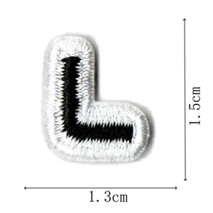Black and white embroidered letter L patch detail view showing compact size and fine stitches.