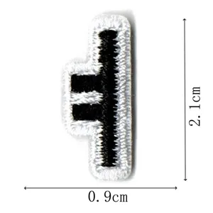 Black and white embroidered patch detail shot, small letter badge, 2.1x0.9cm size closeup.