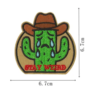 Close up detail of the cute crying cactus cowboy embroidered patch, showing fine stitching work.