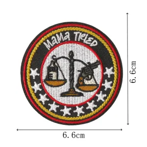 Round embroidered patch with MAMA TRIED design, scales and revolver motif, clothing accessory.