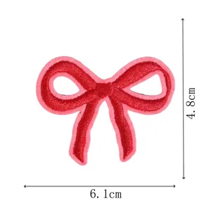 Red bow embroidery patch size detail, cute clothing accessory and repair patch for bags.