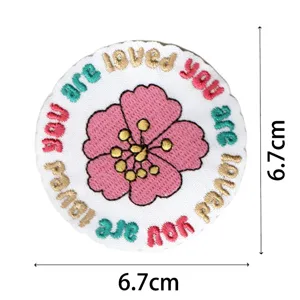 Round embroidered cloth patch with pink flower and positive quote, perfect for DIY bags and clothes.