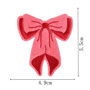 Pink bow embroidered patch detail shot, premium fabric clothing accessory, size 4.9x5.5cm.