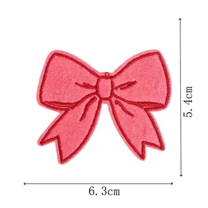 Pink bow embroidered cloth patch for clothing repair and bag decoration. Size: 6.3x5.4cm.