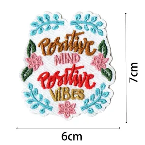Detailed close-up view of the colorful embroidered cloth patch with floral design