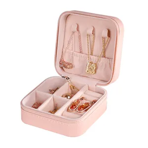 Portable pink travel jewelry box with velvet interior, perfect for rings, earrings, and necklaces.