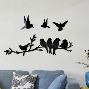 Detail view of 3D acrylic mirror magpie tree branch wall sticker in cozy living room decor.