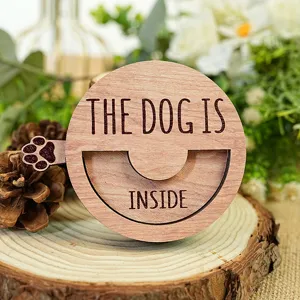 Wooden pet status sign detail, engraved with text and cute paw print, perfect for door decoration.