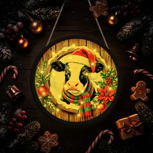Christmas cow hanging sign detail shot with glowing LED lights and festive holiday decor.