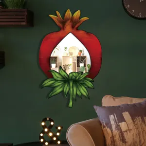 Close-up detail of pomegranate wooden decorative mirror showing boho art in home.