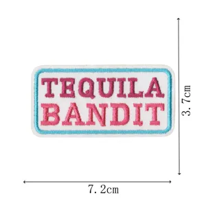 Tequila Bandit embroidered patch, pink letters with blue border, DIY clothing accessory.
