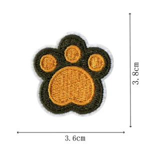 Cute animal paw embroidery patch for clothing decoration, close-up detail view.