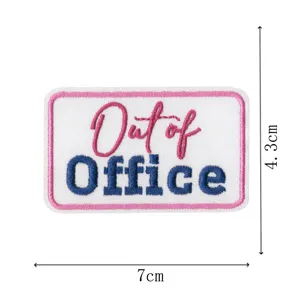 Detailed view of the Out of Office embroidered patch with pink border, measuring 7x4.3cm.