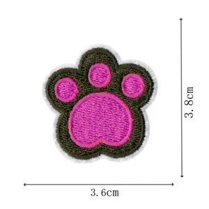 Close-up detail of the cute embroidered paw patch, featuring vibrant pink pads and clean stitching.