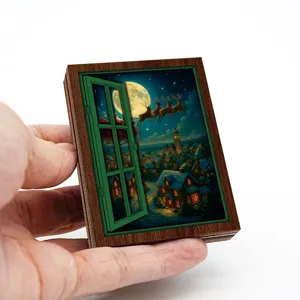 Close-up detail of the Christmas wooden window fridge magnet featuring a snowy village scene.