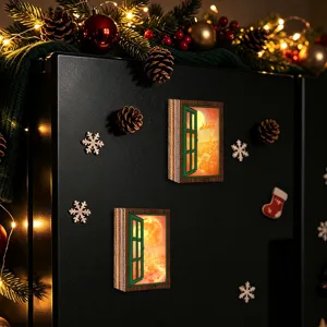 Close-up detail of glowing Christmas window fridge magnet with festive scene, wooden decor.