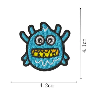 Blue cartoon monster embroidered patch detail, cute DIY clothing and bag accessory.