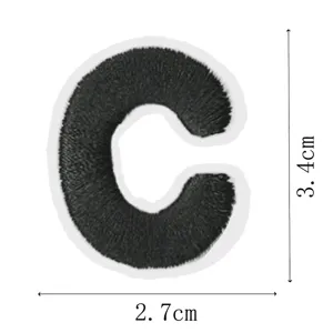 Close-up detail of a black embroidered letter C patch, showing fine stitching and clear dimensions.
