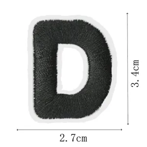 Close-up detail showcasing the precise size and shape of the black letter D embroidery patch.