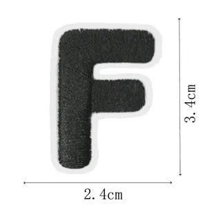 Black letter F embroidery patch close-up view, durable cloth sticker for DIY clothes decoration.