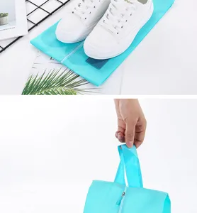 Detail view of the portable blue oxford cloth travel shoe storage bag with smooth zipper.