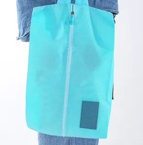 Portable cyan travel shoe storage bag with zipper closure and durable oxford cloth.