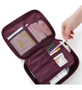 Portable travel cosmetic bag with multiple mesh compartments and waterproof fabric for storage.