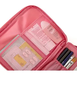 Pink travel toiletry cosmetic bag detail, waterproof mesh pockets and brush holder slots.