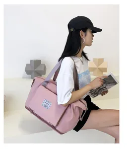 Pink travel duffel bag for women and men, large capacity gym bag for weekend trips.