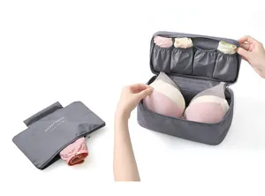 Grey portable travel bra and underwear organizer storage bag with multiple compartments.