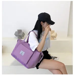 Purple travel gym bag for women and men, foldable lightweight weekend tote bag with pockets.